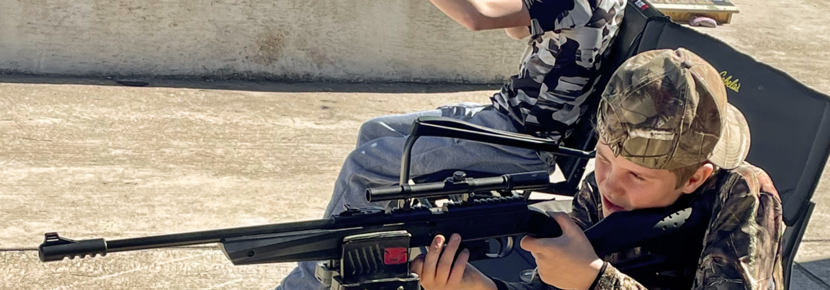 Young boys shooting pellet rifles