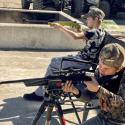 Young boys shooting pellet rifles