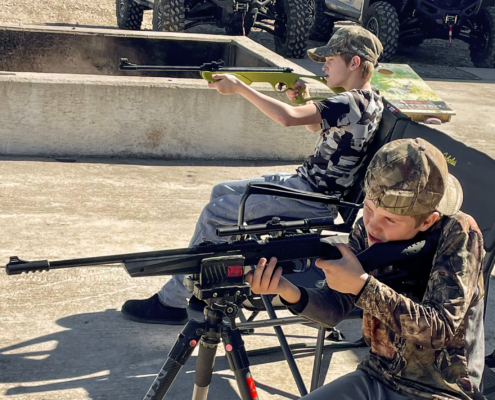 Young boys shooting pellet rifles