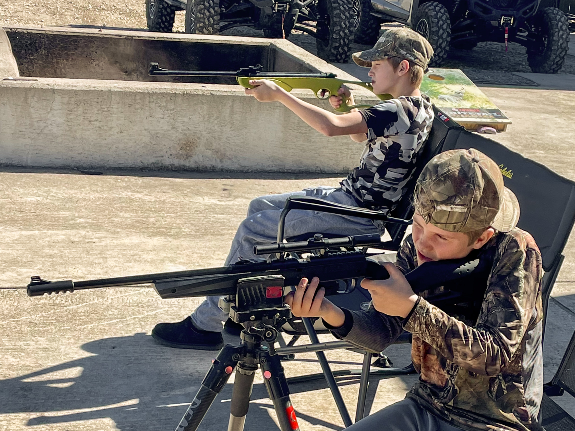 Young boys shooting pellet rifles